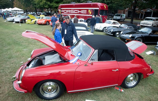 Tom Godfrey and his daughter Margaux look over a Porsche during the Atlanta Concours D'Elegance car show at Tyler Perry Studios in Atlanta on Sunday, October 20, 2019.  STEVE SCHAEFER / SPECIAL TO THE AJC