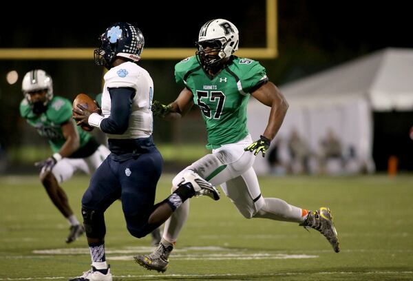 November 20, 2015 - Roswell, Ga: Roswell linebacker Tre Lamar (57) pursues Camden County quarterback Antonio Hamilton (6) in the fourth quarter of their second round game of the Class AAAAAA playoffs Friday, November 20, 2015, in Roswell, Ga. Roswell won 34-15. PHOTO / JASON GETZ