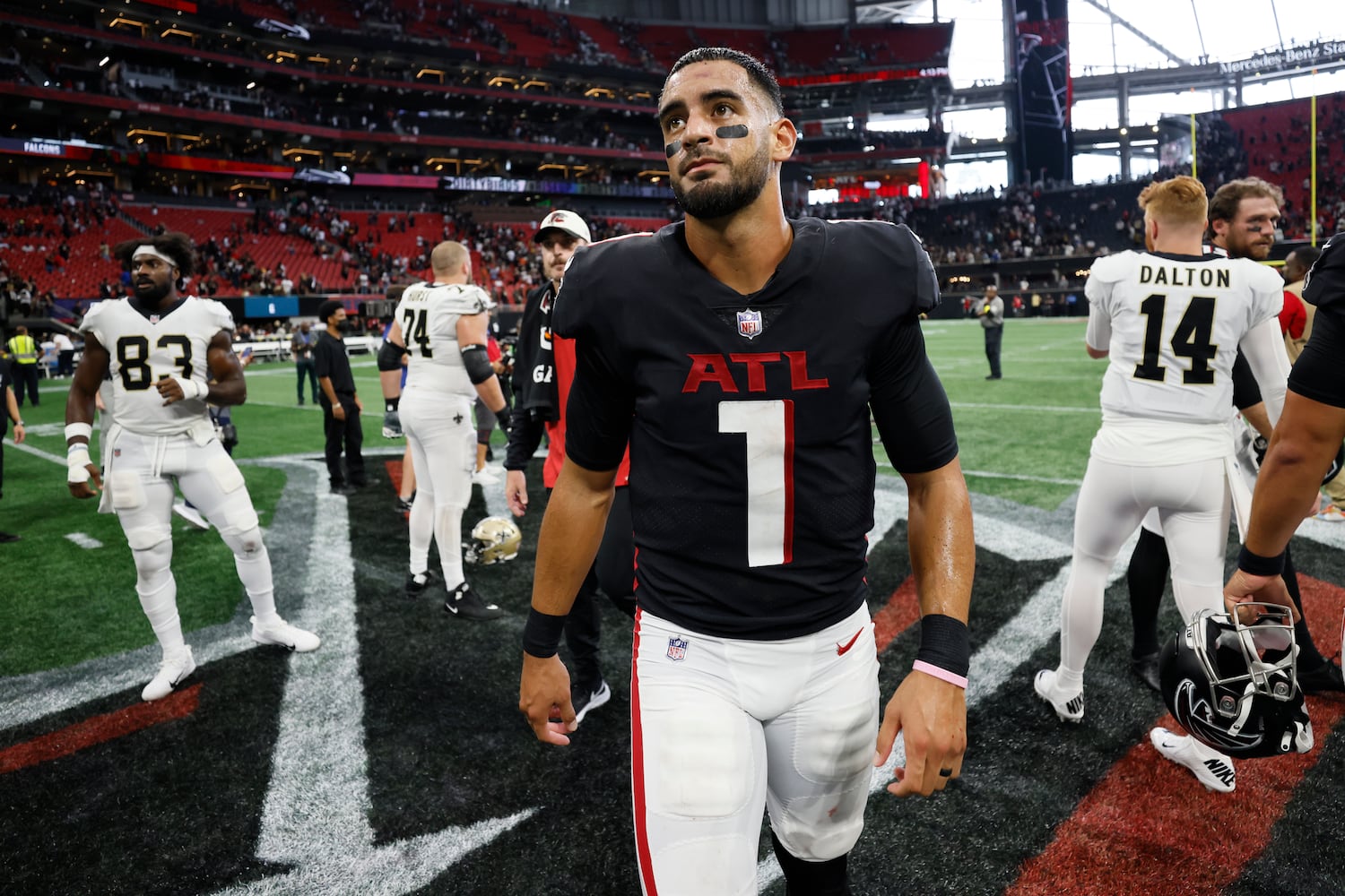 Falcons quarterback Marcus Mariota leaves the field Sunday at Mercedes-Benz Stadium. (Miguel Martinez / miguel.martinezjimenez@ajc.com)