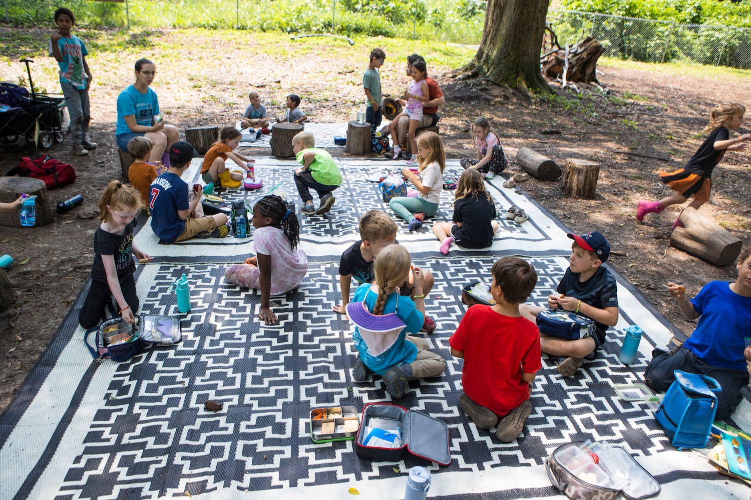 Summer campers eat lunch at Our Giving Garden on Wednesday, June 7, 2023, in Mableton, Georgia. Our Giving Garden is a nonprofit community garden that donates fresh produce to families without access to it. CHRISTINA MATACOTTA FOR THE ATLANTA JOURNAL-CONSTITUTION.