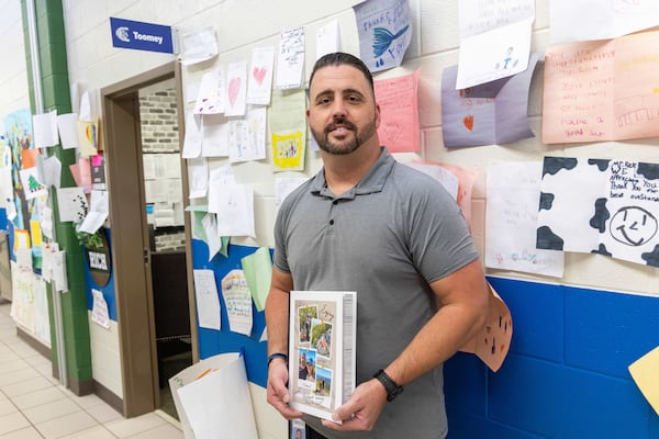 Kelly Mill Elementary School custodian Richard Toomey, named national custodian of the year by Cintas Corporation, is surrounded by letters of support outside his office. PHIL SKINNER FOR THE ATLANTA JOURNAL-CONSTITUTION