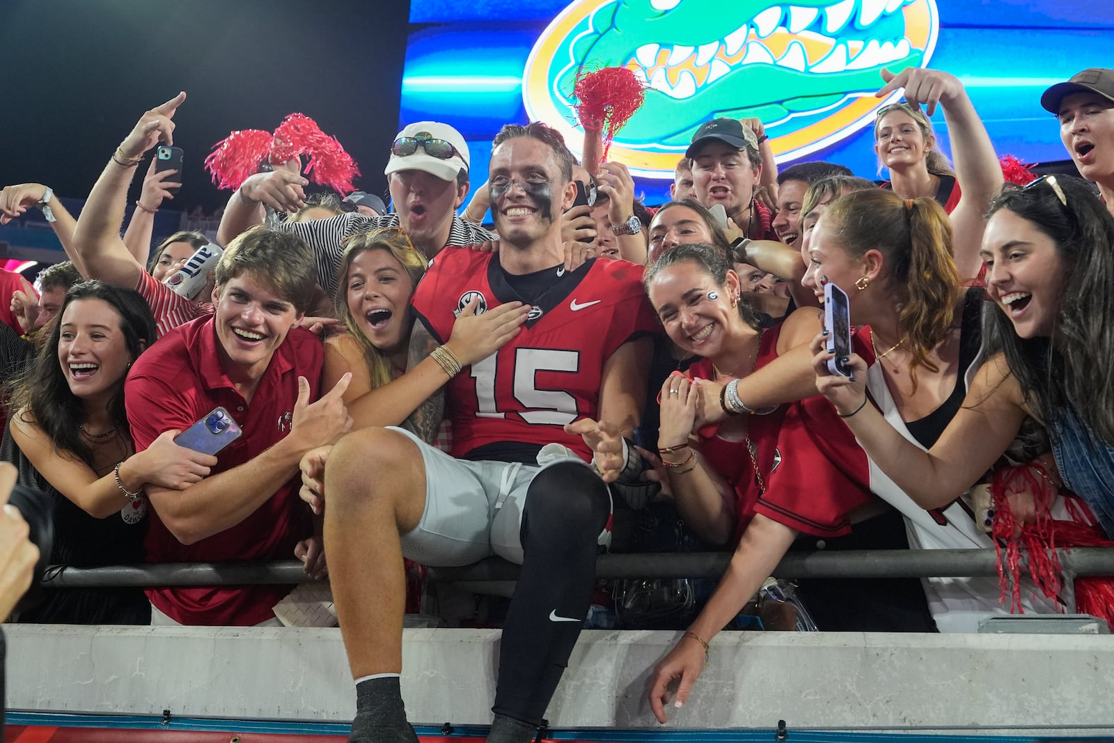 Georgia quarterback Carson Beck, center, celebrates with fans after defeating Florida in an NCAA college football game, Saturday, Nov. 2, 2024, in Jacksonville, Fla. (AP Photo/John Raoux)