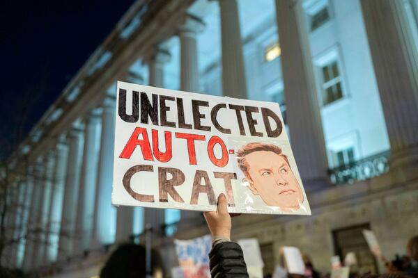 FILE - People protest during a rally against Elon Musk outside the Treasury Department in Washington, Tuesday, Feb. 4, 2025. (AP Photo/Jose Luis Magana, File)