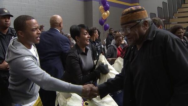 T.I. and Atlanta Mayor Keisha Lance Bottoms hand out turkeys Tuesday ahead of Thanksgiving.