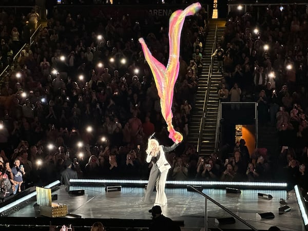 Cyndi Lauper uses artist Daniel Wertzel's "Air Fountain" installation in the center of State Farm Arena to maneuver a multi-colored sheet during "True Colors" as part of her encore Nov. 10, 2024. RODNEY HO/rho@ajc.com