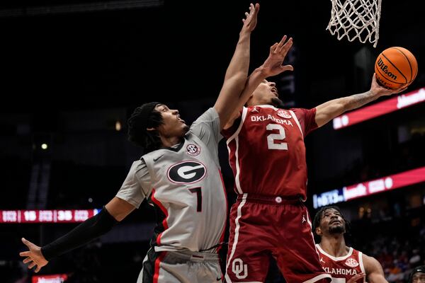 Oklahoma guard Brycen Goodine (2) shoots against Georgia guard Dakota Leffew (1) during the second half of an NCAA college basketball game at the Southeastern Conference tournament, Wednesday, March 12, 2025, in Nashville, Tenn. (AP Photo/George Walker IV)