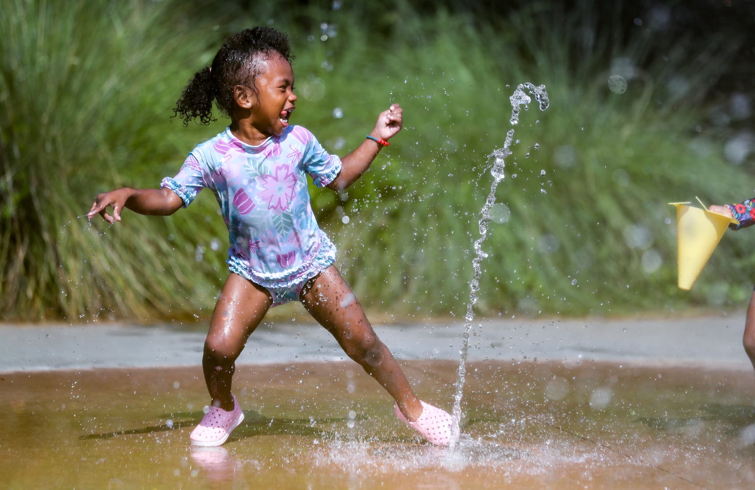 June 13, 2022 Atlanta:  Layla Hall-2 didn’t pay any attention to the heat index on Monday, June 13, 2022 as she frolicked in the water at the Historic Fourth Ward Park Splash Pad in Atlanta. Her mother, Ki Hall (not pictured) brings her usually three times a week. A combination of 90-degree heat and humidity pushed heat index values into the triple digits Monday and all across North Georgia. According to Channel 2 Action News meteorologist Eboni Deon, There could be showers and storms in the mix Tuesday, but Deon said even a 40% chance of rain won’t do much to tamp down the heat. “We’re going to do it all over again on Tuesday,” she said. “Heat index values anywhere from 105 in the Atlanta area, maybe approaching 110 in a few spots. Not the kind of heat you want to spend any time outdoors in.” Highs in the 90s are in the forecast every day this week and into the weekend, according to the latest forecast.  (John Spink / John.Spink@ajc.com)

