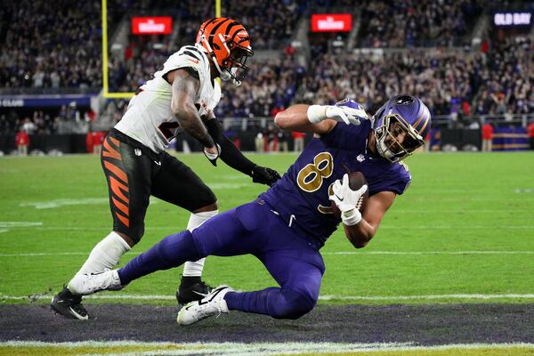 Baltimore Ravens tight end Mark Andrews (89) scores a touchdown past Cincinnati Bengals safety Geno Stone (22) during the second half of an NFL football game, Thursday, Nov. 7, 2024, in Baltimore. (AP Photo/Nick Wass)