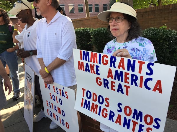 Sally Page and her husband, Rick, carry signs during the Families Belong Together rally in Atlanta on Saturday, June 30, 2018. is Sally Page, also of Atlanta. The local event and similar rallies around the nation on Saturday were to protest U.S. immigration policies that separate children from their parents. (Photo: Danny Robbins/drobbins@ajc.com)