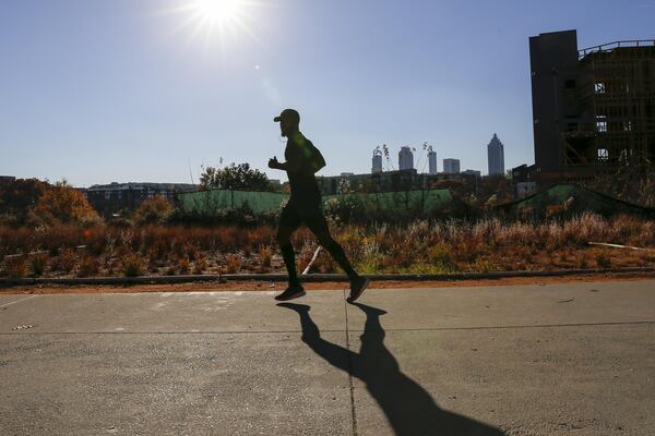 The sun casts a long shadow as a man jogs along the Atlanta Beltline near the Old Fourth Ward neighborhood. ALYSSA POINTER/ALYSSA.POINTER@AJC.COM