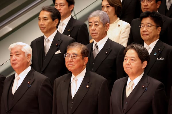 Japanese Prime Minister Shigeru Ishiba, bottom center, accompanied by his new cabinet members poses for photo at his office in Tokyo Monday, Nov. 11, 2024. (Yoshikazu Tsuno/Pool Photo via AP)