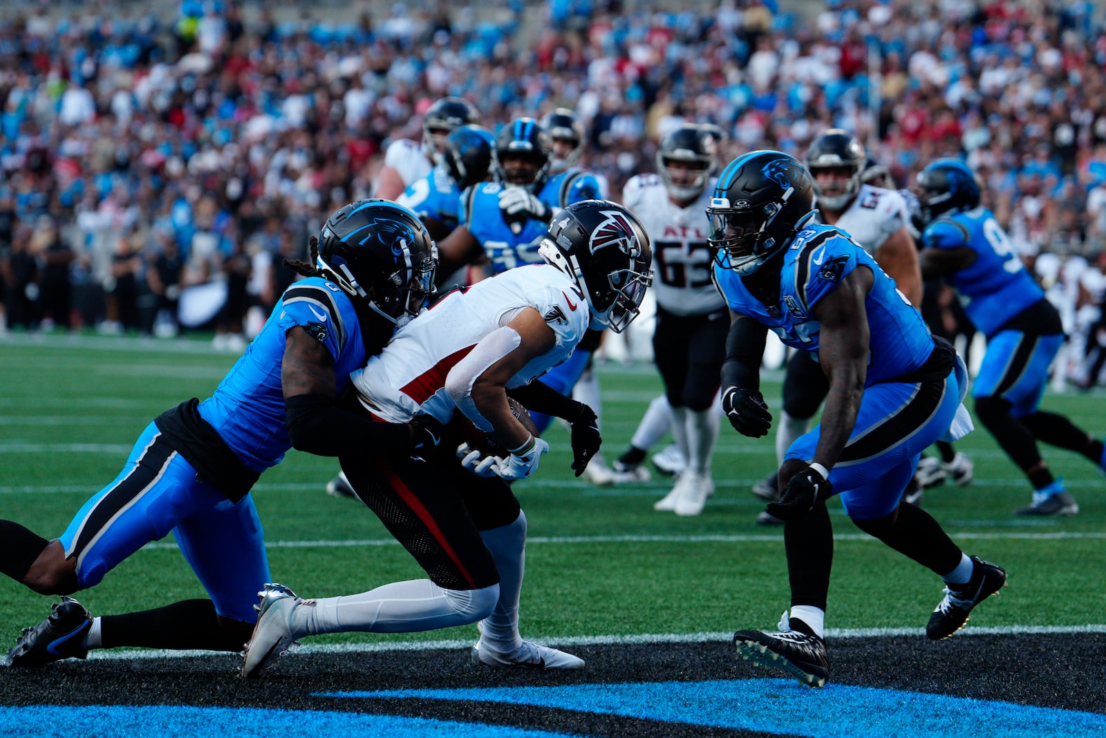 Atlanta Falcons wide receiver Drake London (5) scores a touchdown against Carolina Panthers cornerback Jaycee Horn (8) in the first half of an NFL football game in Charlotte, N.C., Sunday, Oct. 13, 2024. (AP Photo/Jacob Kupferman)