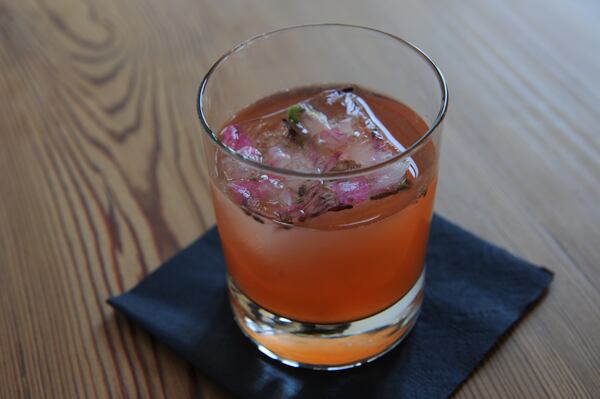 From the drink menu: Time Invested- tequila, pear, Aperol, lemon, green tea and choice of celery or locally grown wildflowers in a single ice cube. (BeckySteinPhotography.com)