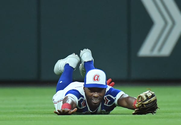 The Braves' Travis Demeritte (48) makes a catch on a ball hit by Milwaukee Brewers' left fielder Christian Yelich (22) to end the 6th inning at Truist Park on Saturday, May 7, 2022.  (Hyosub Shin / Hyosub.Shin@ajc.com)