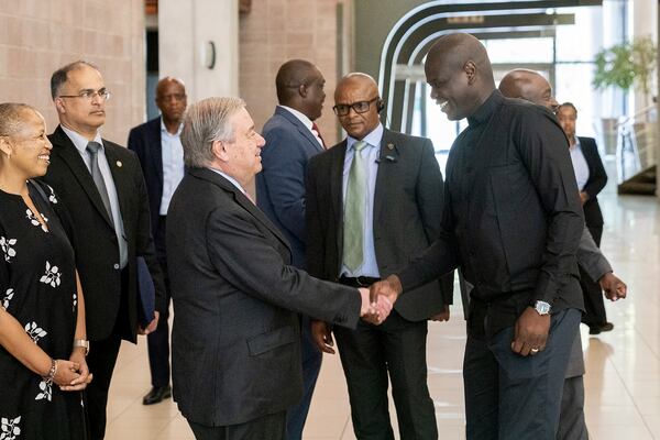 South African Minister of International Relations and Cooperation, Ronald Lamola, front right, and the Secretary General of the United Nations, Antonio Guterres, front left, shake hands during their meeting in Pretoria, South Africa. Wednesday, Dec. 11, 2024. (AP Photo/Shiraaz Mohamed)