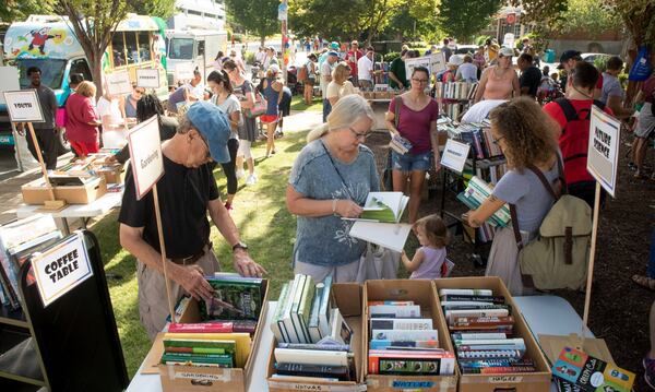 Carolyn Haessler (center) looks over some dollar gardening books at the Friends of Decatur Library book sale during the AJC Decatur Book Festival in 2018. STEVE SCHAEFER / SPECIAL TO THE AJC