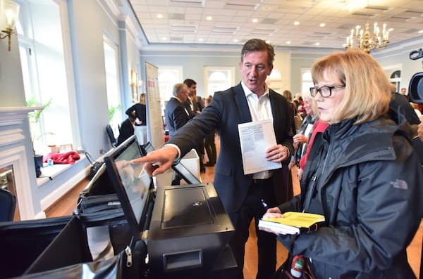 Bill Murphy with Clear Ballot demonstrates his company’s paper ballot system at The Depot on Thursday. Election companies demonstrated voting systems to the public and to officials, showing how Georgia could switch to paper ballots. HYOSUB SHIN / HSHIN@AJC.COM