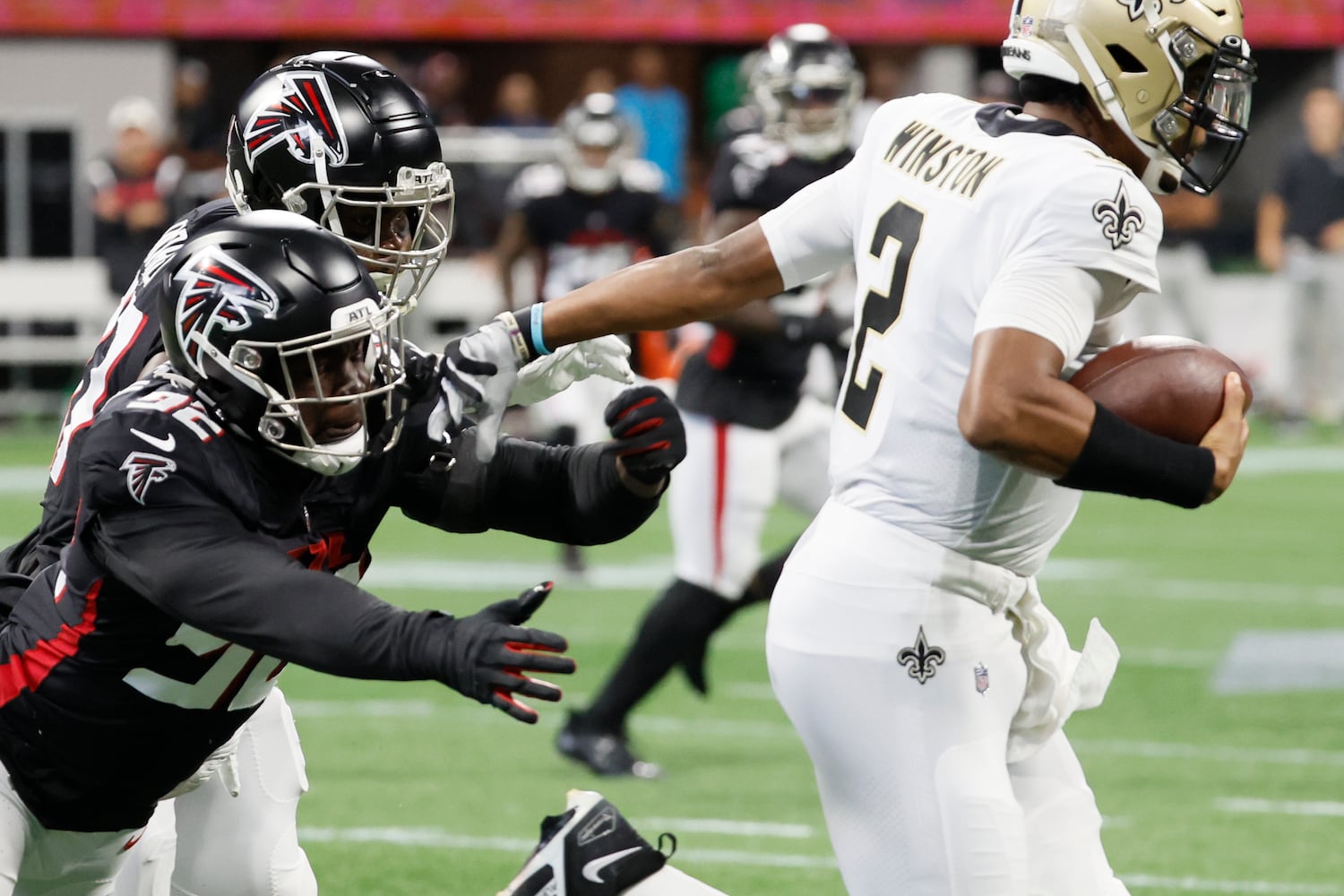 Falcons linebacker Ade Ogundeji chases Saints quarterback Jameis Winston during the second quarter Sunday at Mercedes-Benz Stadium. (Miguel Martinez / miguel.martinezjimenez@ajc.com)
