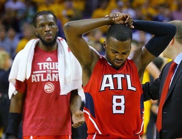 Atlanta Hawks Shelvin Mack (8) walks off the court coming out of the game followed by DeMarre Carroll as the Hawks fall 118-88 to the Cavaliers for the sweep in game four of the Eastern Conference Finals on Tuesday, May 26, 2015, in Cleveland. (Curtis Compton/Atlanta Journal-Constitution via AP) MARIETTA DAILY OUT; GWINNETT DAILY POST OUT; LOCAL TELEVISION OUT; WXIA-TV OUT; WGCL-TV OUT