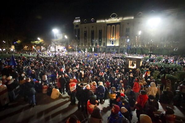 Protesters pour into the streets following the country's ruling party suspended negotiations to join the European Union until 2028, rallying outside the parliament building in Tbilisi, Georgia, Friday, Nov. 29, 2024. (AP Photo/Zurab Tsertsvadze)