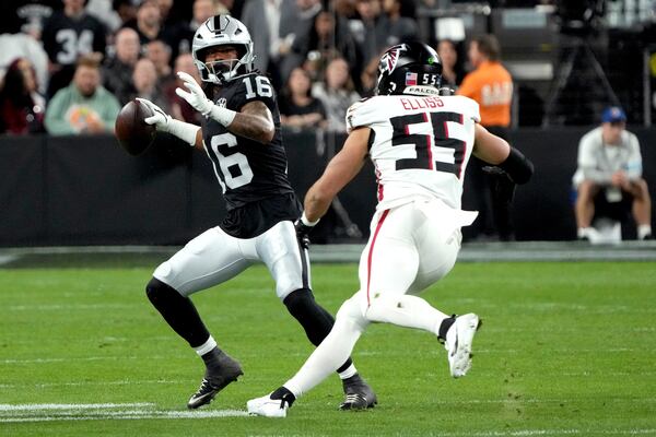 Las Vegas Raiders wide receiver Jakobi Meyers (16) tries to escape from Atlanta Falcons linebacker Kaden Elliss (55) during the second half of an NFL football game Monday, Dec. 16, 2024, in Las Vegas. (AP Photo/Rick Scuteri)