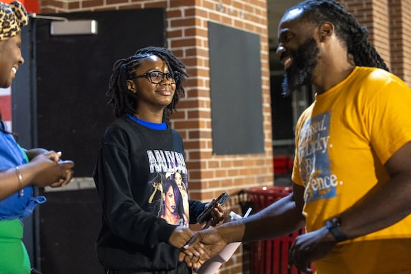 Taylor Brown (center), a 13-year-old trumpet player from Berkmarr High School, meets with CAU's interim band director Torre Goodson (right), who is looking to mine local talent for the Mighty Marching Panthers marching band at Panther Stadium at Clark Atlanta University in Atlanta on Thursday, October 10, 2024. (Arvin Temkar / AJC)