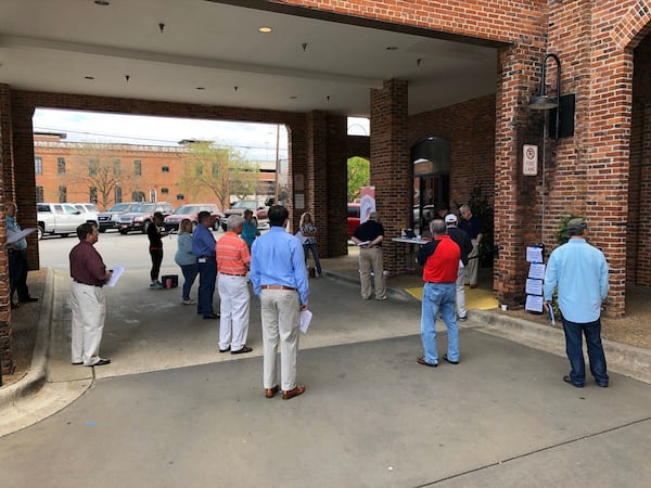 About 18 people huddled in a parking lot for the Muscogee County GOP meeting. Joseph Brannan