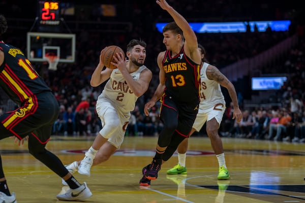 Cleveland Cavaliers guard Ty Jerome (2), left, attempts to make a pass againt Atlanta Hawks guard Bogdan Bogdanovic (13) during the first half of an Emirates NBA Cup basketball game between the Cleveland Cavilers and the Atlanta Hawks on Friday, Nov. 29, 2024, in Atlanta. (AP Photo/Erik Rank)