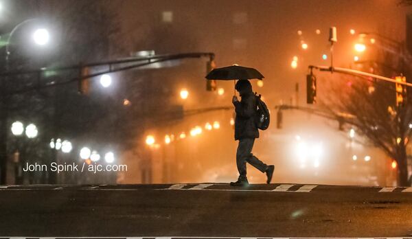 A fog horn would be useful Tuesday morning on Andrew Young International Boulevard as low clouds and rain showers blanket the city.