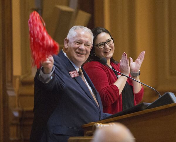 Georgia House Speaker David Ralston shows off his new “gavel” as he stands next to Betsy Lynch at the podium Monday during the first day of the 2018 General Assembly at the Georgia State Capitol. (Photo by Phil Skinner)