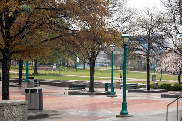 Downtown Atlanta’s Centennial Olympic Park was nearly empty on a rainy Tuesday, March 24, 2020. Atlanta Mayor Keisha Lance Bottoms has ordered Atlantans to shelter in place in an attempt to curb the spread of COVID-19. (Photo: Rebecca Wright for The Atlanta Journal Constitution)