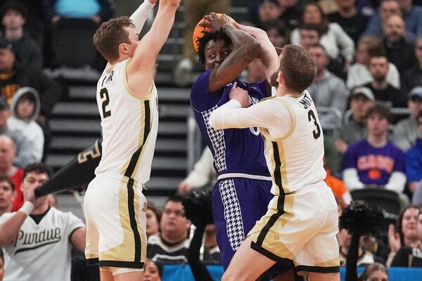 High Point forward Terry Anderson, center, is trapped by Purdue defenders during the first half in the first round of the NCAA college basketball tournament, Thursday, March 20, 2025, in Providence, R.I. (AP Photo/Charles Krupa)