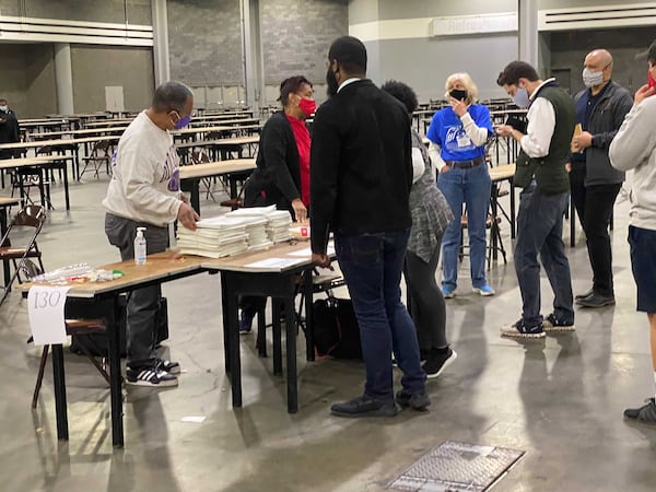 The final team finishing the recount at 3:57 p.m. at the Georgia World Congress Center for Fulton County. (Photo: Adrianne Murchison/AJC)