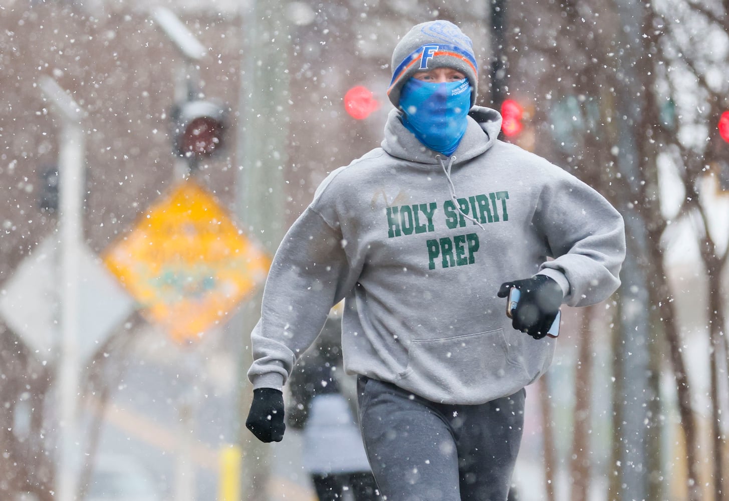 A person jogs along the beltline near Krog Street and Dekalb Avenue as the snow starts in Metro Atlanta in the afternoon on Tuesday, January 21, 2025.