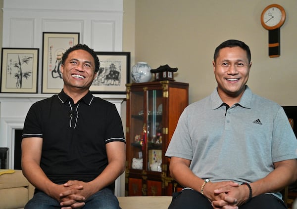 March 31, 2021 Norcross - Robert (left) and Elliott Peterson, sons of one of Atlanta spas shooting victims, Yong Ae Yue, share a smile as they recall their late mother at their late motherÕs home in Norcross on Wednesday, March 31, 2021. (Hyosub Shin / Hyosub.Shin@ajc.com)