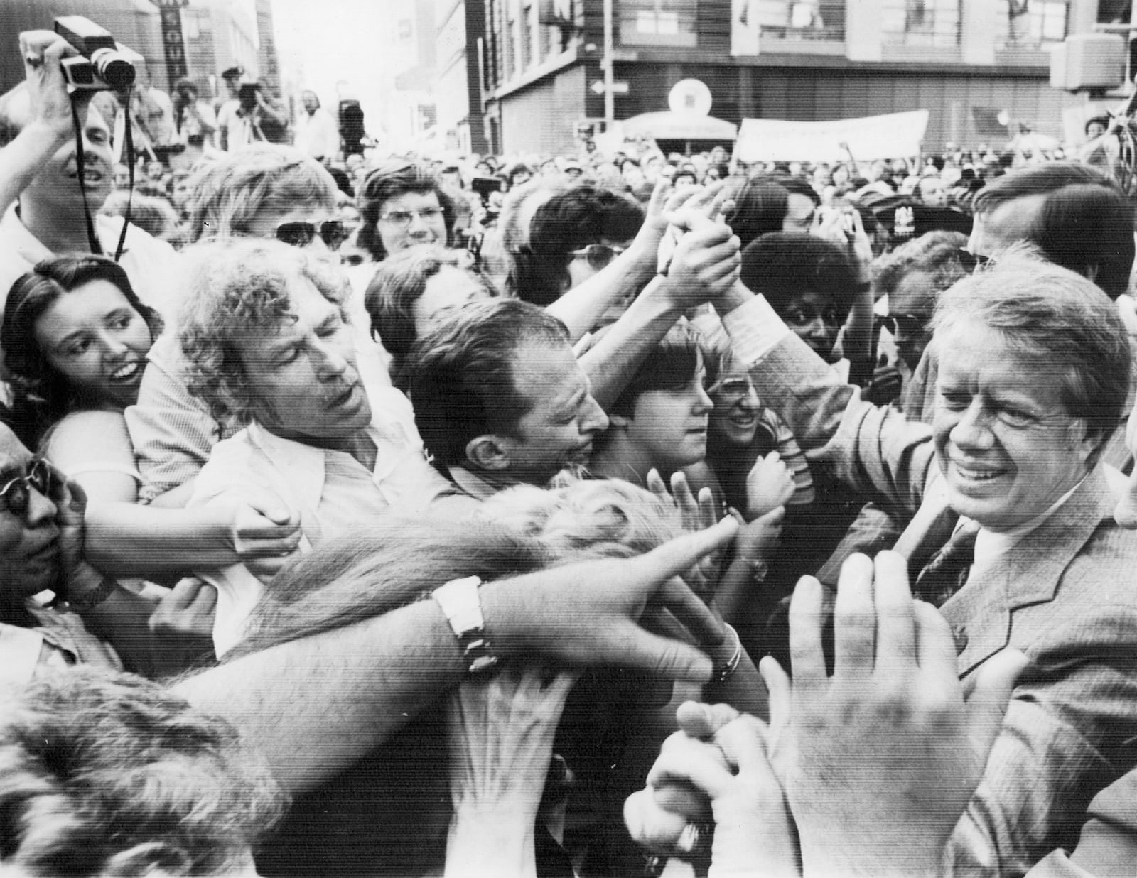 Carter is welcomed to New York City by a sea of hands as he arrives to attend the Democratic National Convention. (Associated Press)