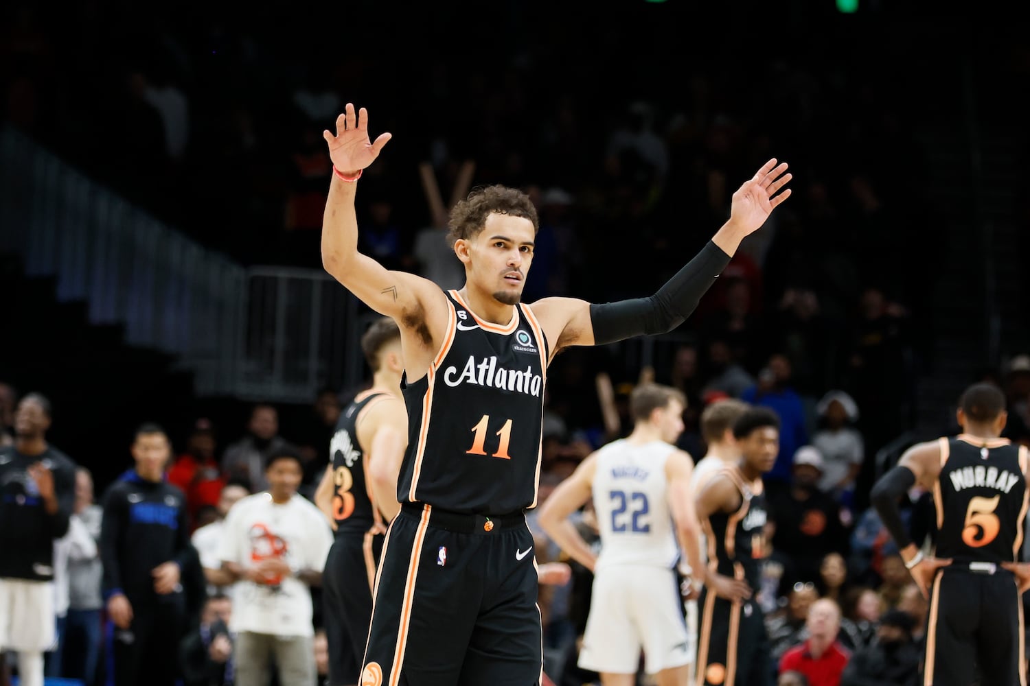 Hawks guard Trae Young tries to quiet the crowd after guard Dejounte Murray (not pictured) got fouled in the last second of the game against the Magic on Monday night in Atlanta. (Miguel Martinez / miguel.martinezjimenez@ajc.com)