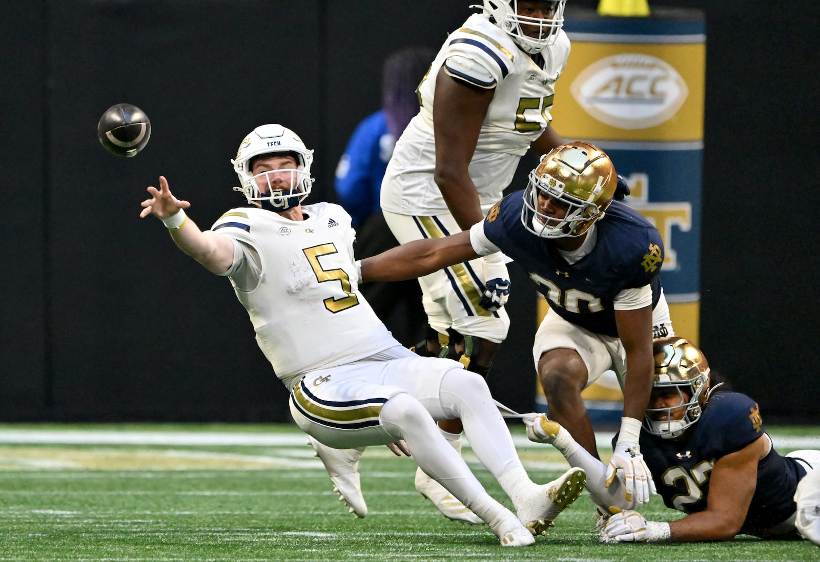 Georgia Tech quarterback Zach Pyron (5) throws the football as he falls down during the second half in an NCAA football game at Mercedes-Benz Stadium, Saturday, October 19, 2024, in Atlanta. Notre Dame won 31-13 over Georgia Tech. (Hyosub Shin / AJC)