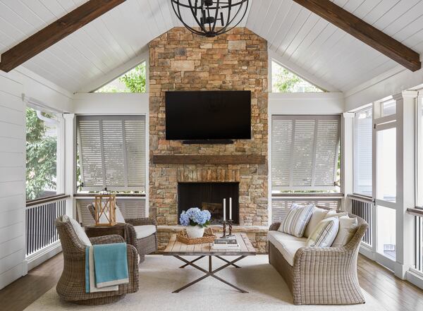 This screened-in porch offers not only views of the outdoors, but the sounds and sensations of nature. Courtesy of Kelly Blackmon of Emily Followill Photography/Liz Williams Interiors