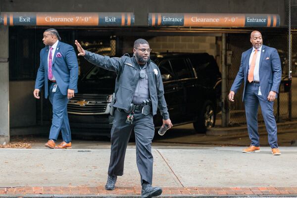 A guard blocks traffic as Gov. Brian Kemp leaves the Fulton County Courthouse in Atlanta on Tuesday, November 15, 2022, where Kemp testified before a grand jury examining whether former President Donald Trump and his allies criminally meddled in Georgia’s 2020 elections. (Arvin Temkar / arvin.temkar@ajc.com)