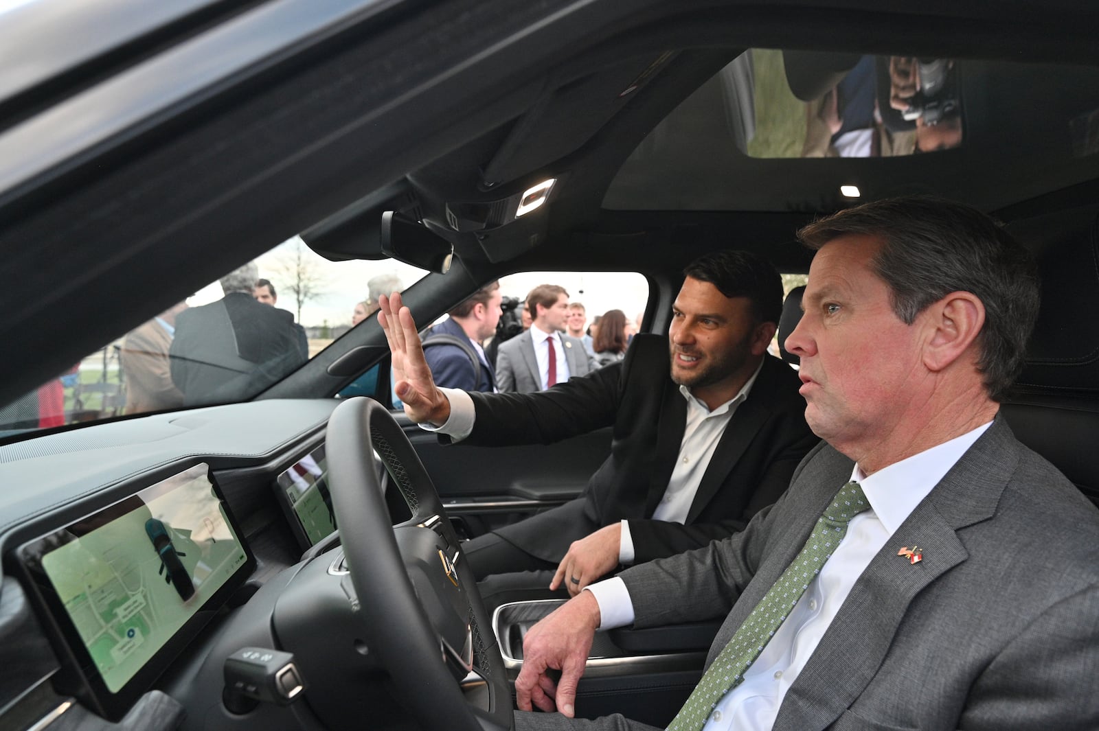 December 16, 2021 Atlanta - Jimmy Knauf (left), EVP of Facilities at Rivian, shows interior of R1T electric truck to Georgia Governor Brian Kemp during a press conference at Liberty Plaza across from the Georgia State Capitol in Atlanta on Thursday, December 16, 2021. Electric vehicle maker Rivian on Thursday confirmed its plans to build a $5 billion assembly plant and battery factory in Georgia, which Gov. Brian Kemp called “the largest single economic development project ever in this state’s history.” (Hyosub Shin / Hyosub.Shin@ajc.com)