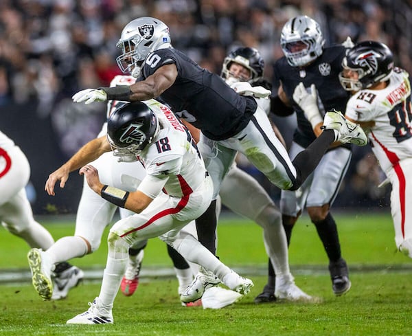 Atlanta Falcons quarterback Kirk Cousins (18) is taken down after a rushed pass by Las Vegas Raiders linebacker Divine Deablo (5) during the first half of their NFL game at Allegiant Stadium on Monday, Dec. 16, 2024, in Las Vegas. (L.E. Baskow/Las Vegas Review-Journal/TNS)