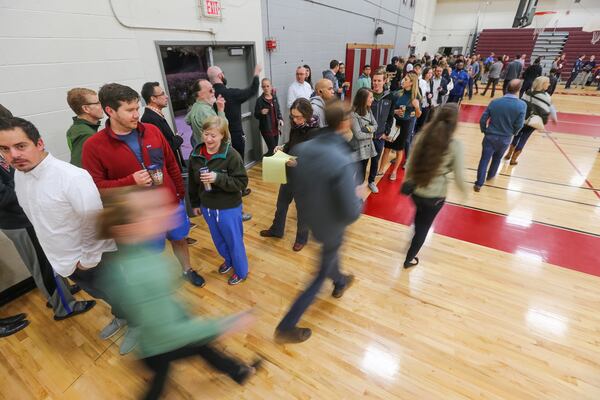 Lines form as voting starts Tuesday at Grady High School. JOHN SPINK / JSPINK@AJC.COM