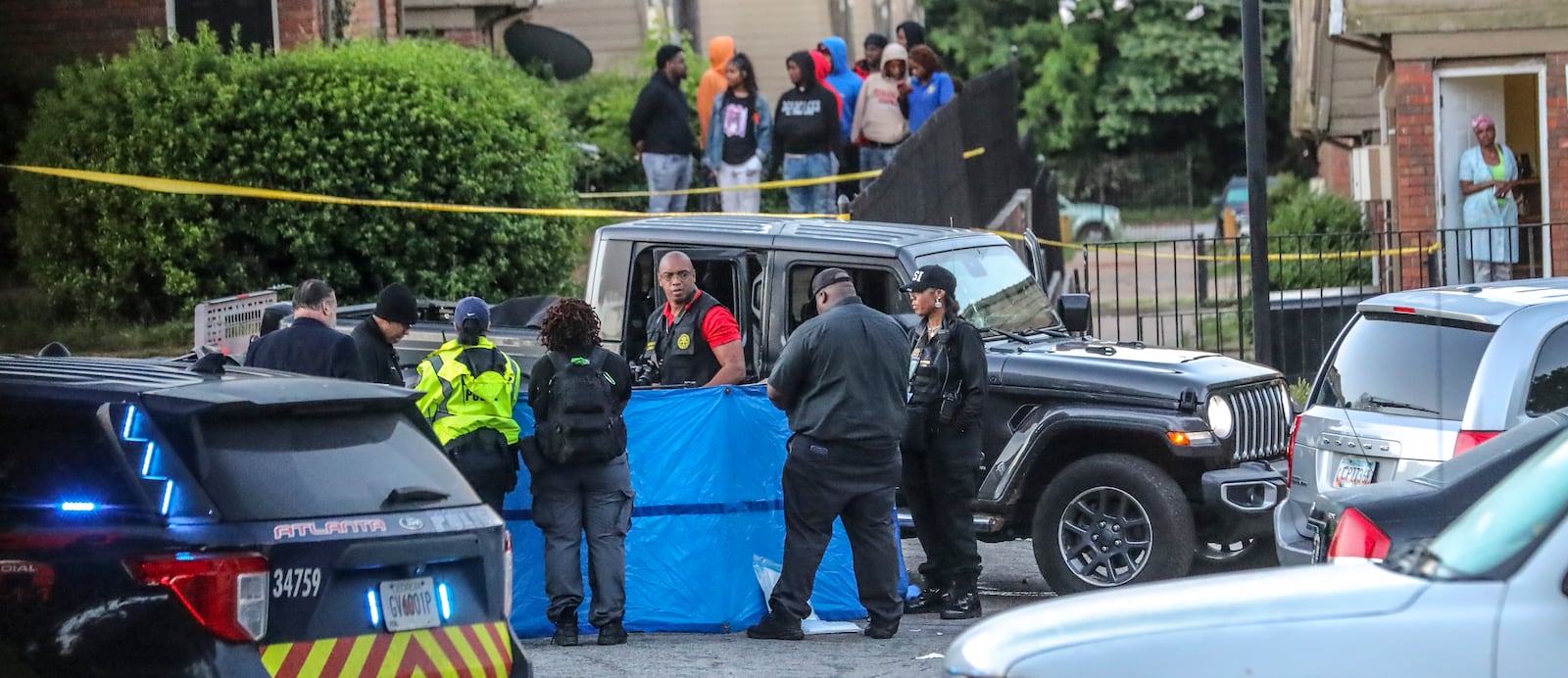 Atlanta police investigate after the body of a shooting victim was found in May at Forest Cove Apartments. Another person was wounded in the shooting. Since 2009, 19 homicides have occurred at Forest Cove, and a judge has ordered that the complex be demolished. (John Spink / John.Spink@ajc.com)