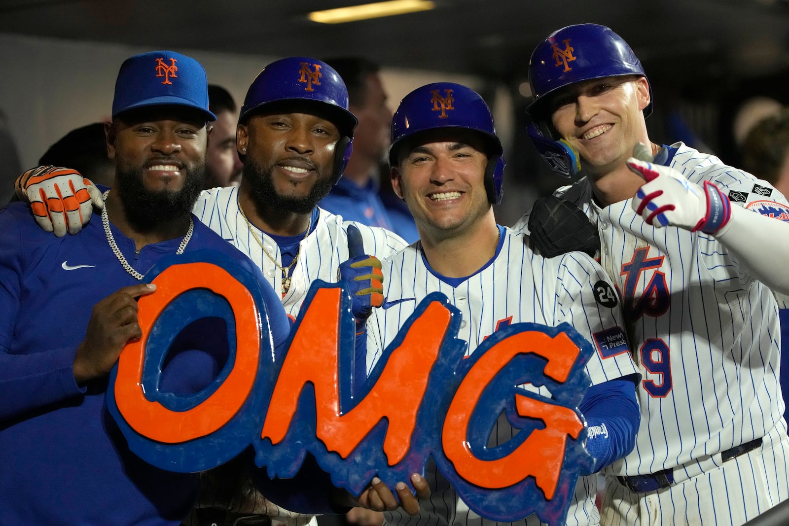 From left, New York Mets' Luis Severino, Starling Marte, Jose Iglesias, and Brandon Nimmo pose with a sign after Nimmo hit a two-run home run during the fourth inning of a baseball game against the Washington Nationals, Wednesday, Sept. 18, 2024, in New York. (AP Photo/Pamela Smith)