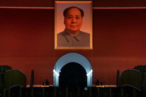 Chinese paramilitary policemen stand guard below a giant portrait of late Chinese leader Mao Zedong hung on Tiananmen Gate in Beijing, China, Wednesday, July 5, 2025. (AP Photo/Ng Han Guan)