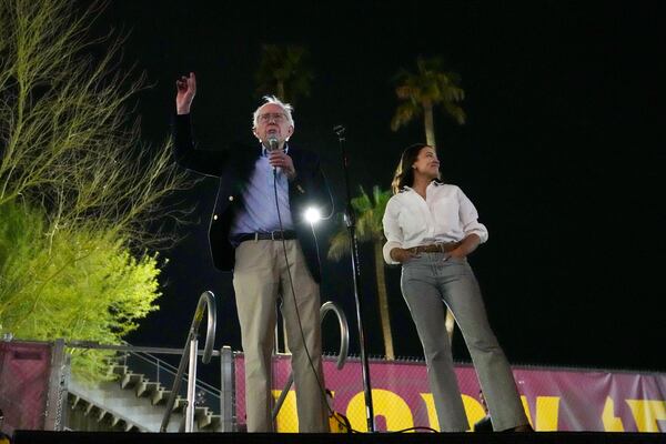 Sen. Bernie Sanders, I-Vt., and Rep. Alexandria Ocasio-Cortez, D-N.Y., speak outside of Arizona State University to the overflow crowd that did not get inside the arena, during a "Fighting Oligarchy" tour event Thursday, March 20, 2025, in Tempe, Ariz. (AP Photo/Ross D. Franklin)