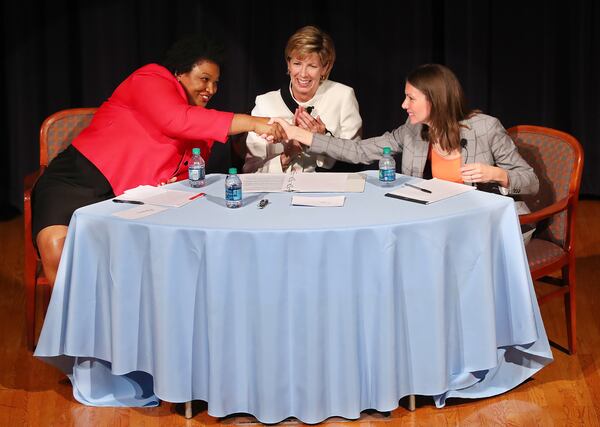  Stacey Abrams (left) and Stacey Evans (right) shake hands at the conclusion of their first forum in Atlanta. Curtis Compton/ccompton@ajc.com