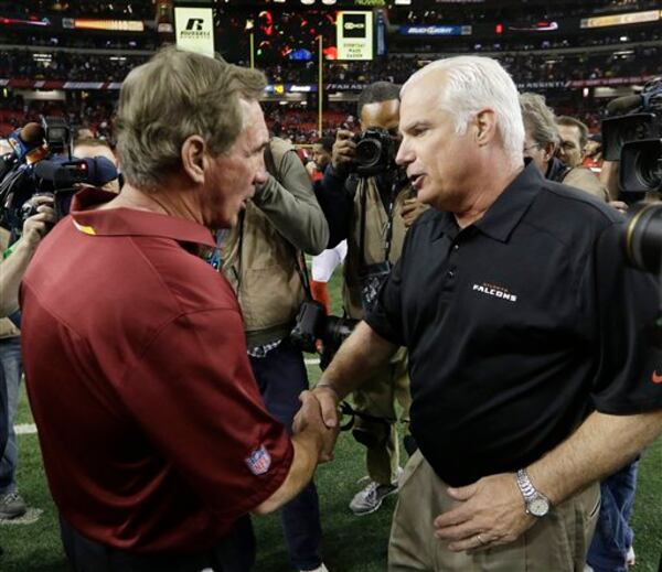 Washington Redskins head coach Mike Shanahan, left, speaks with Atlanta Falcons head coach Mike Smith after the second half of an NFL football game, Sunday, Dec. 15, 2013, in Atlanta. The Atlanta Falcons won 27-26. (AP Photo/John Bazemore) "Just don't come after my job, OK?" (John Bazemore/AP)