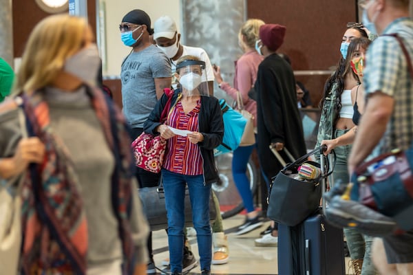 09/04/2020 -Atlanta, Georgia - A woman wearing a face shield and a face mask arrives from her flight into the domestic terminal at Hartsfield-Jackson Atlanta International Airport, Friday, September 4, 2020. (Alyssa Pointer / Alyssa.Pointer@ajc.com)